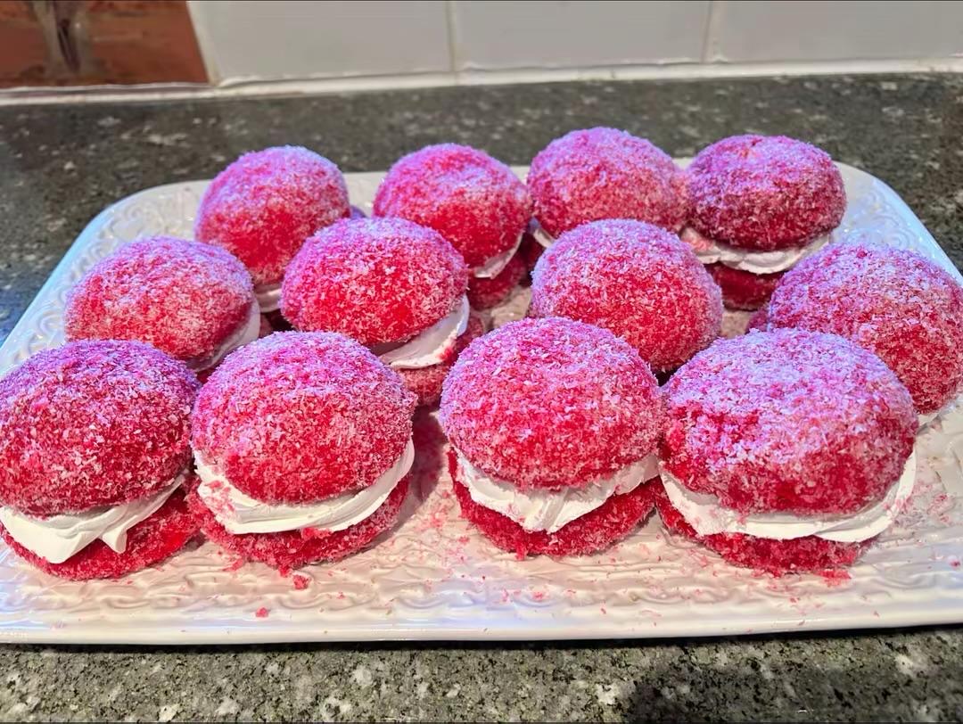 Tray of pink cakes filled with cream