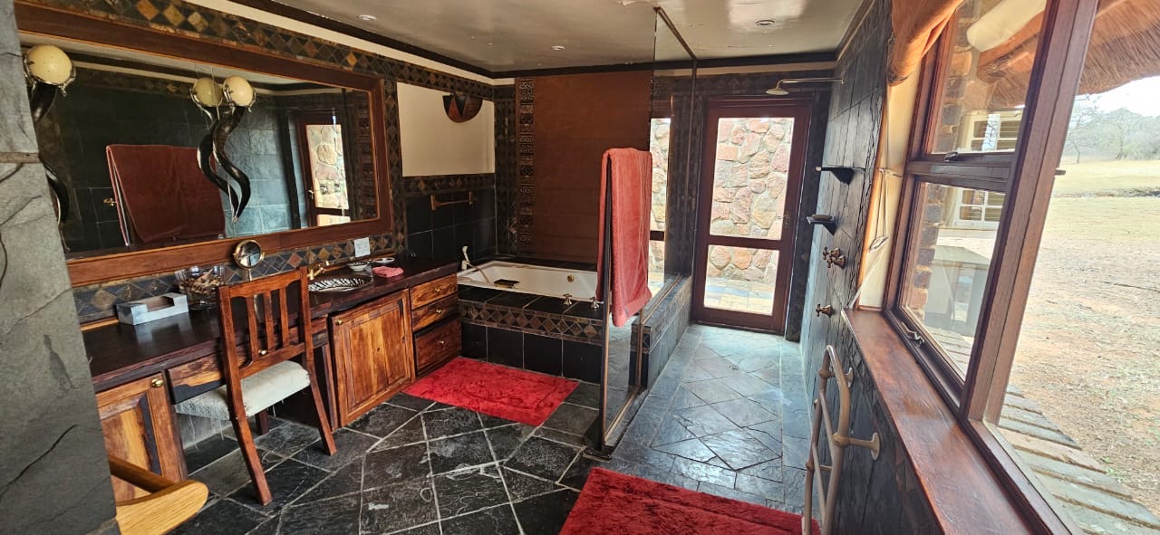 Private chalet bathroom with bathtub, shower and wooden vanity