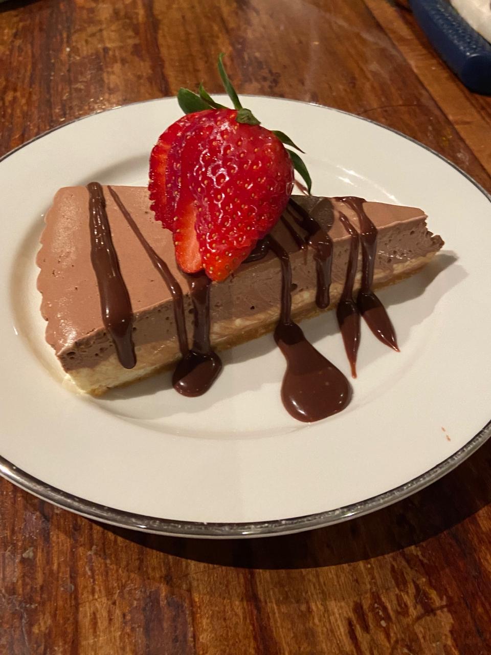 Layered chocolate dessert topped with a strawberry